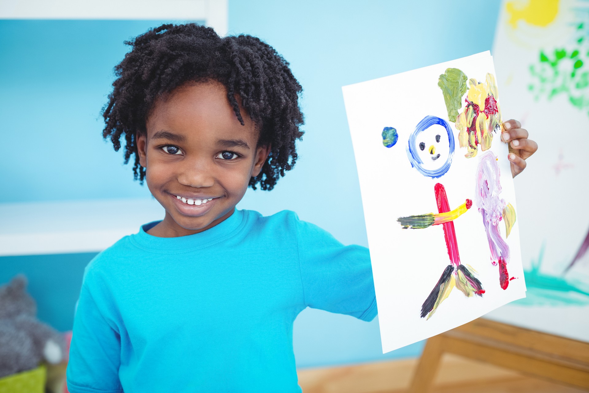 Happy kid enjoying arts and crafts painting