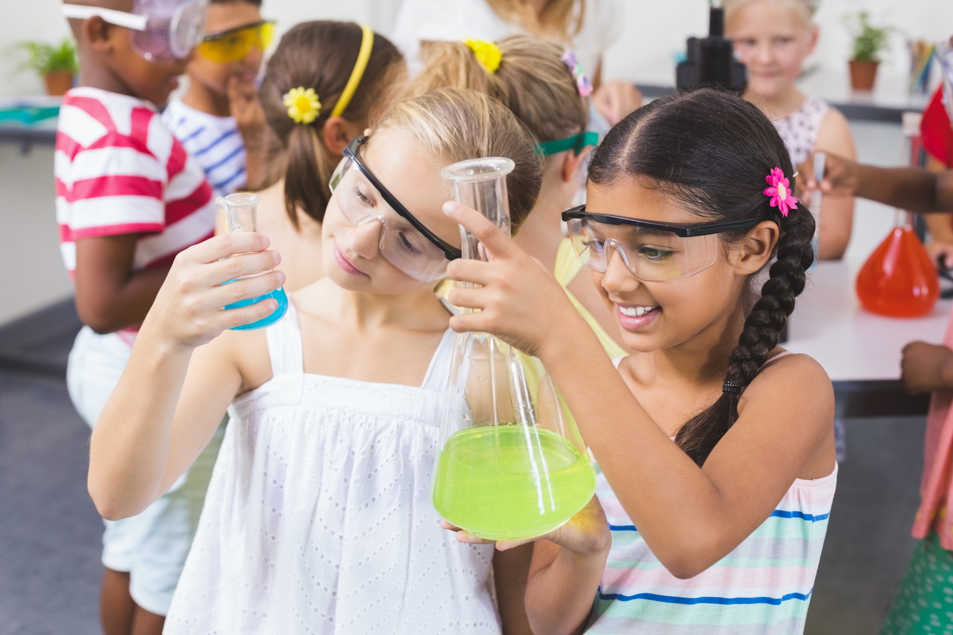 Kids doing a chemical experiment in laboratory