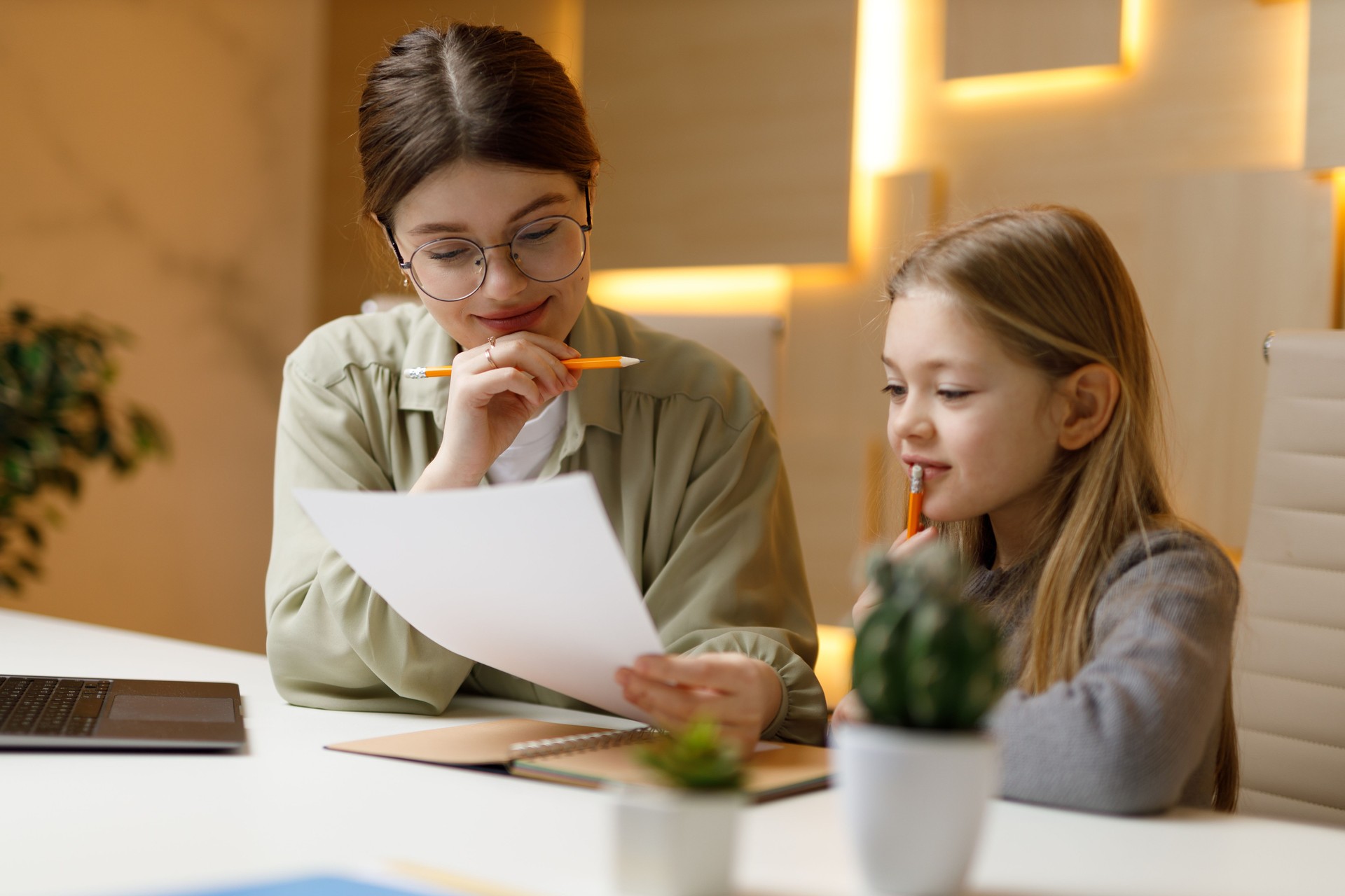 The teacher explains the lesson to the student. Exam results, mom and daughter do homework.